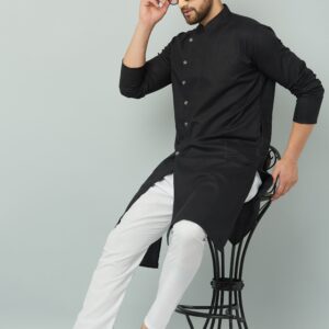 An individual wearing a black kurta and white pants seated on a chair. Indian kurta Teradozz brand